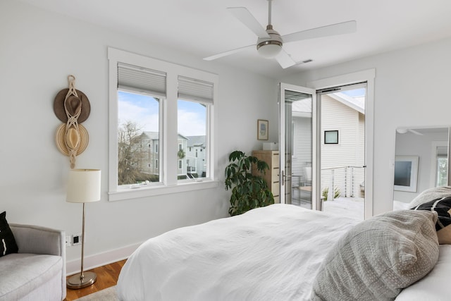 bedroom with ceiling fan, access to exterior, and hardwood / wood-style floors