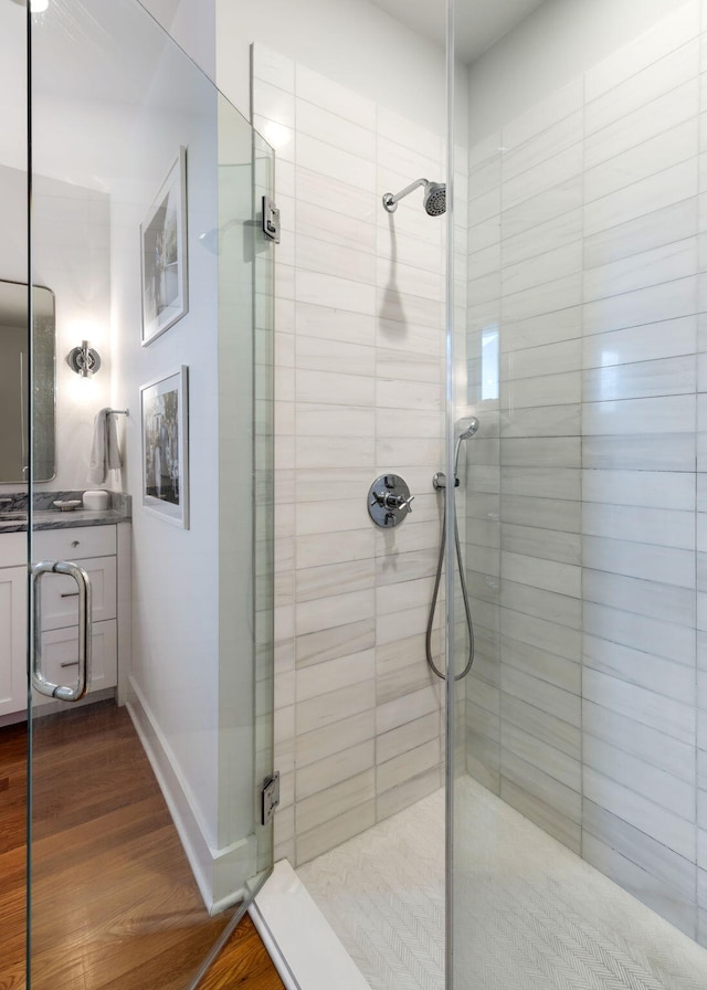 bathroom featuring hardwood / wood-style flooring and walk in shower