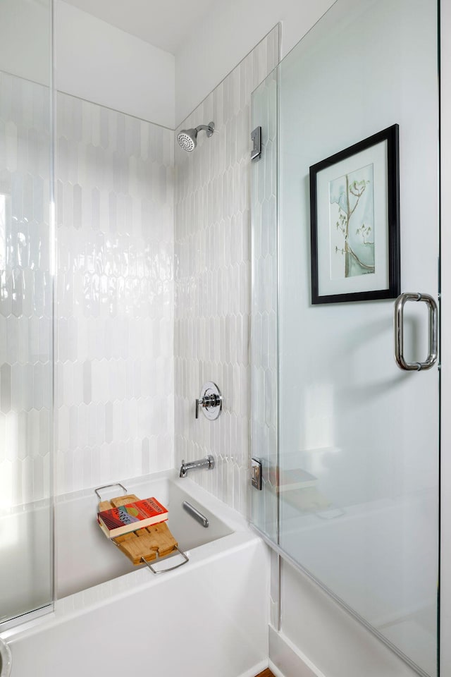 bathroom with shower / bath combination with glass door