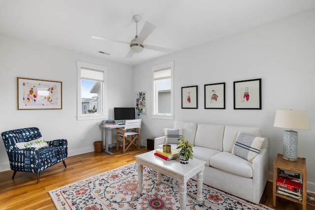 living room featuring wood-type flooring and ceiling fan