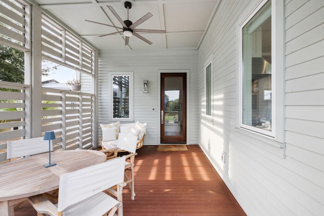 sunroom featuring ceiling fan