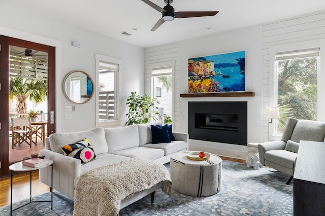 living room with hardwood / wood-style flooring and ceiling fan