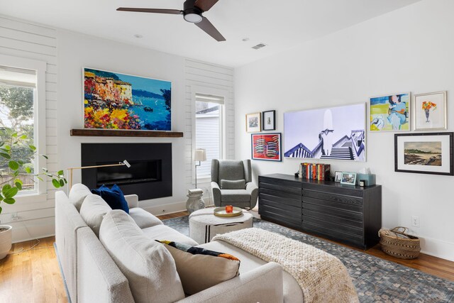 living room with hardwood / wood-style flooring, a wealth of natural light, and ceiling fan