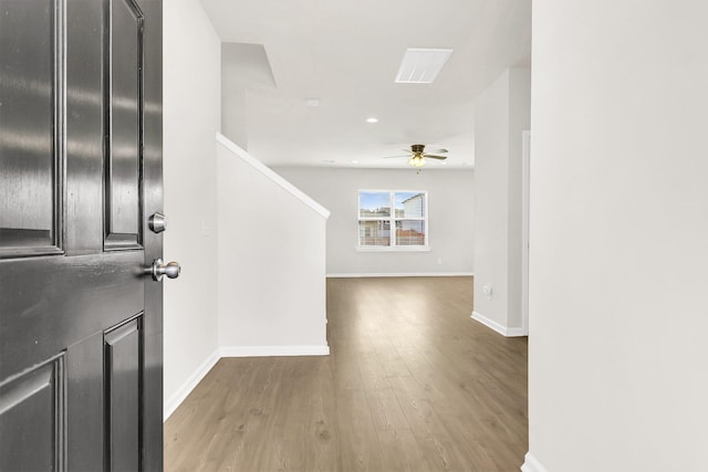 foyer entrance featuring wood-type flooring and ceiling fan