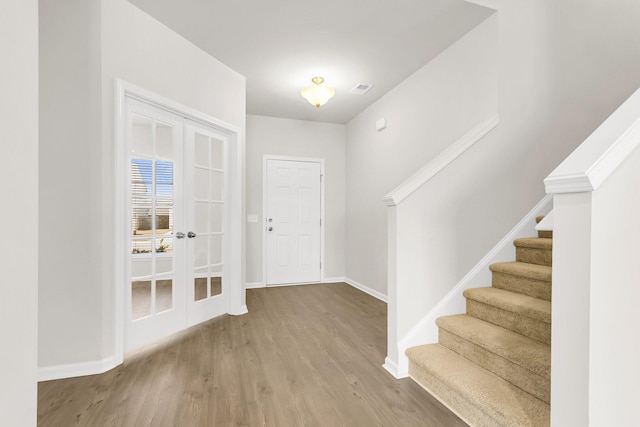 entrance foyer featuring french doors and wood-type flooring