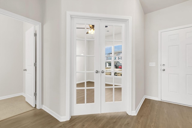 entryway featuring ceiling fan, french doors, and hardwood / wood-style flooring