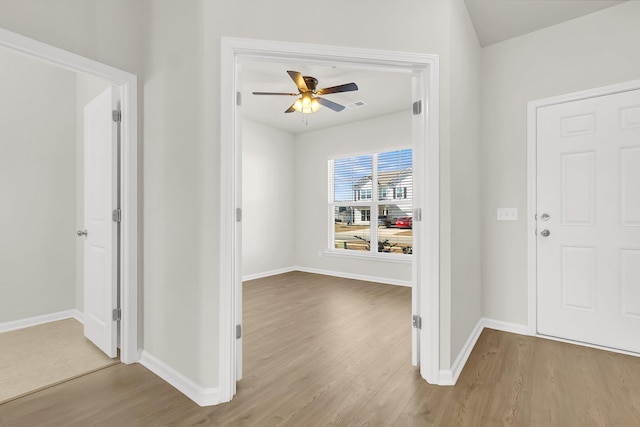 foyer entrance featuring ceiling fan and light wood-type flooring