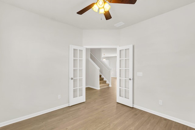 spare room with ceiling fan, light wood-type flooring, and french doors