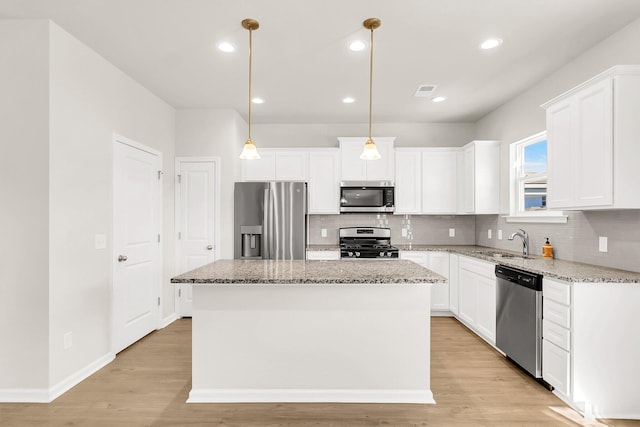 kitchen featuring a center island, white cabinetry, and stainless steel appliances