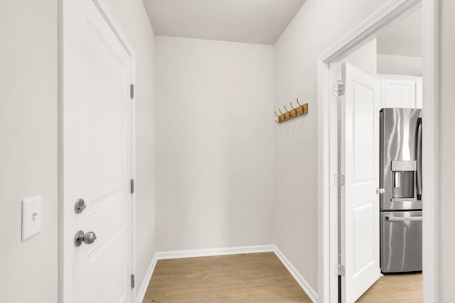 corridor with light hardwood / wood-style floors