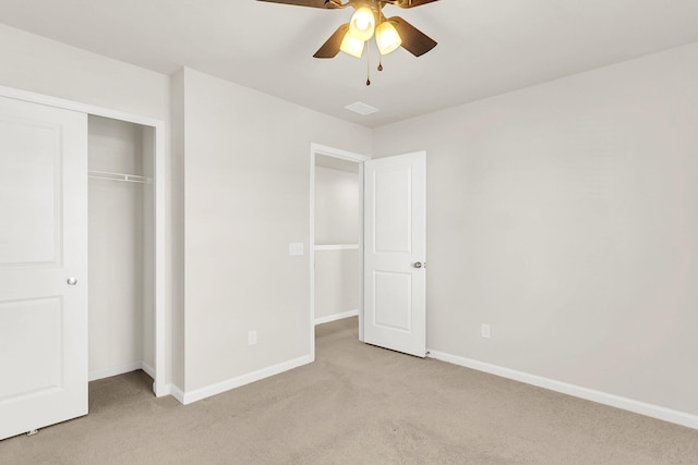 unfurnished bedroom with light carpet, a closet, and ceiling fan