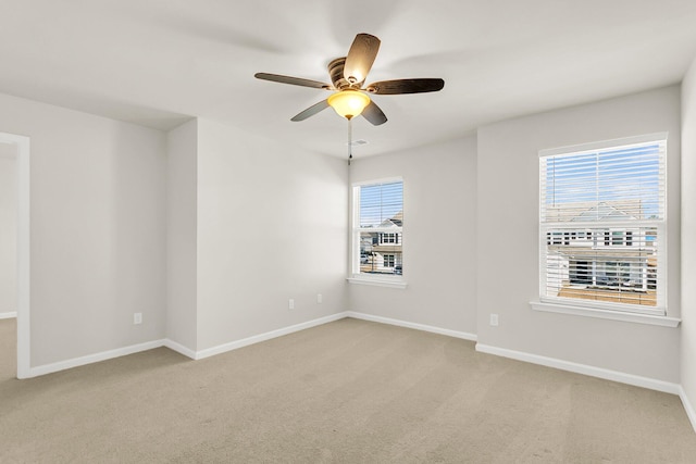 carpeted empty room featuring ceiling fan