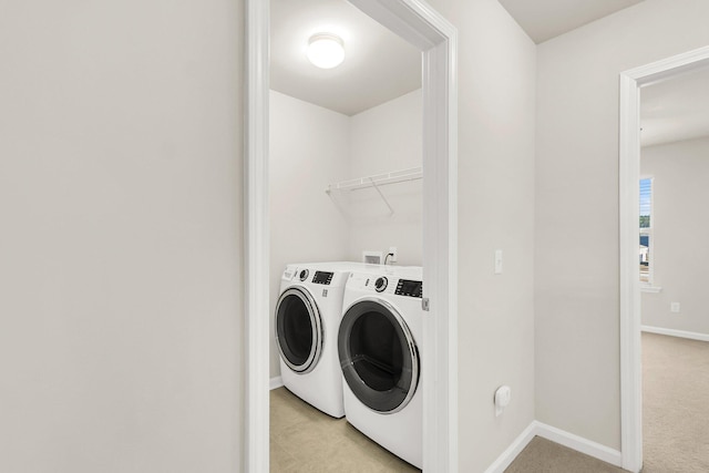 laundry area featuring light colored carpet and independent washer and dryer