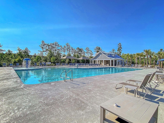 view of swimming pool with a patio area and pool water feature