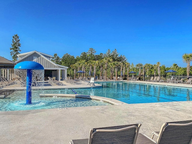 view of swimming pool featuring pool water feature and a patio