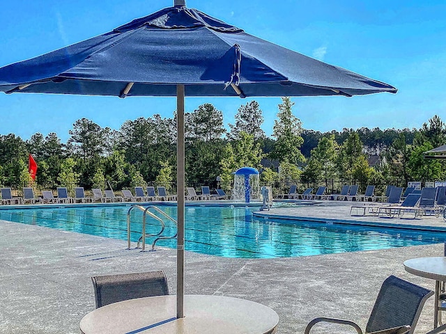 view of pool featuring pool water feature and a patio