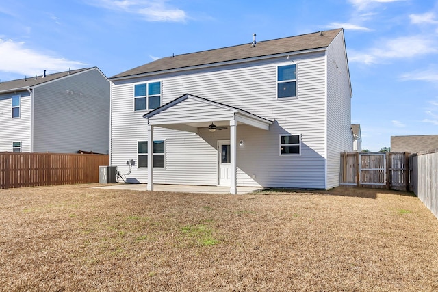 rear view of property with central AC, ceiling fan, a patio area, and a lawn