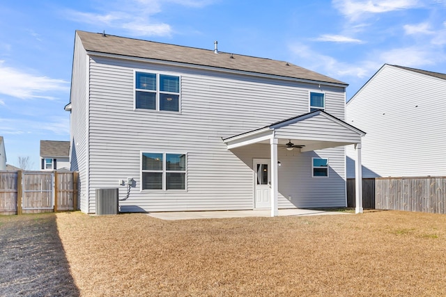 rear view of house featuring a lawn, ceiling fan, a patio area, and central air condition unit