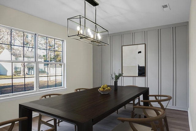 dining room featuring dark hardwood / wood-style floors and a chandelier