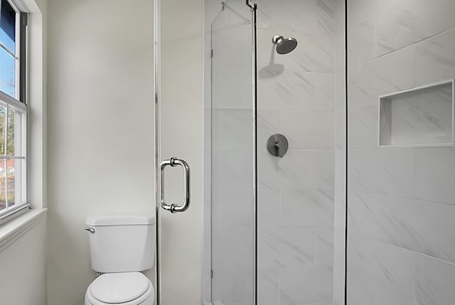 bathroom with walk in shower and toilet