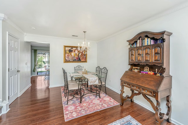 dining space featuring a notable chandelier, dark wood-type flooring, baseboards, and ornamental molding