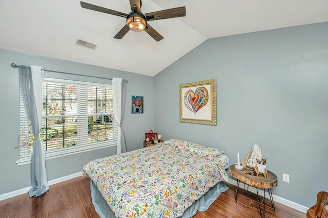 bedroom with visible vents, dark wood-type flooring, baseboards, and vaulted ceiling