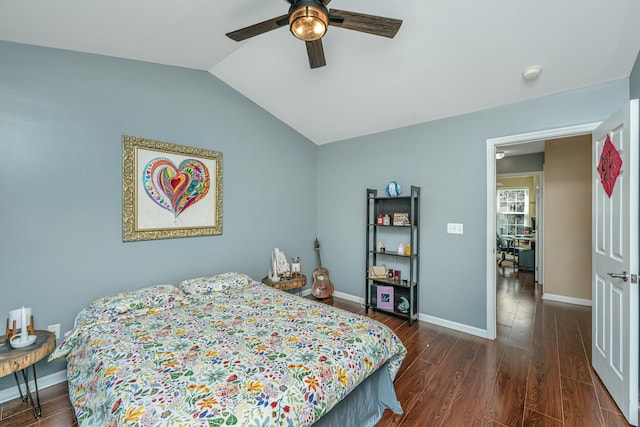 bedroom with dark wood finished floors, vaulted ceiling, a ceiling fan, and baseboards