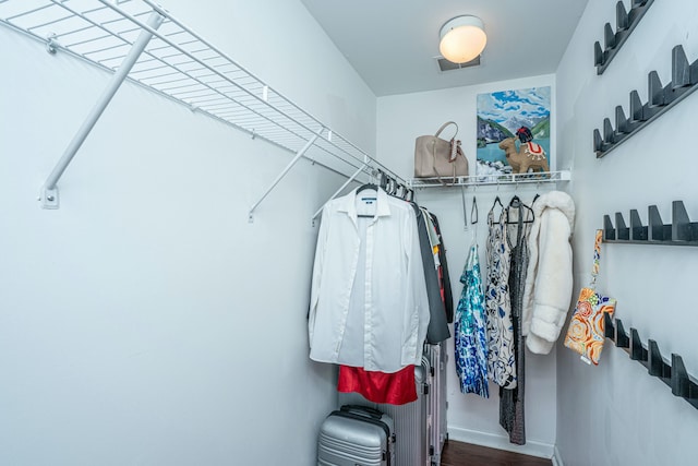 walk in closet with visible vents and wood finished floors