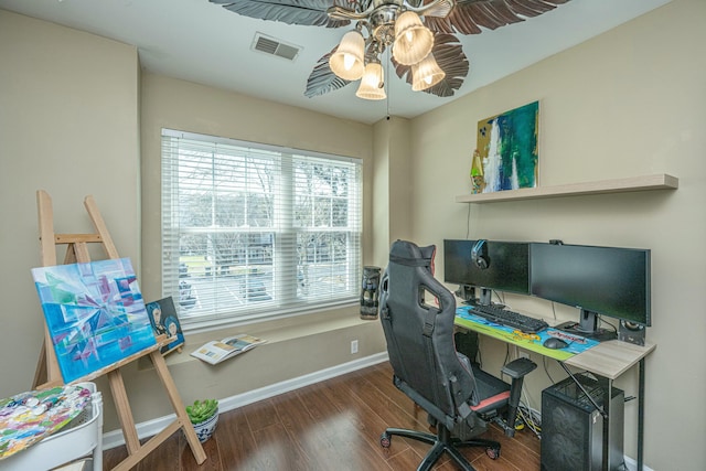 home office featuring wood finished floors, a ceiling fan, visible vents, and baseboards