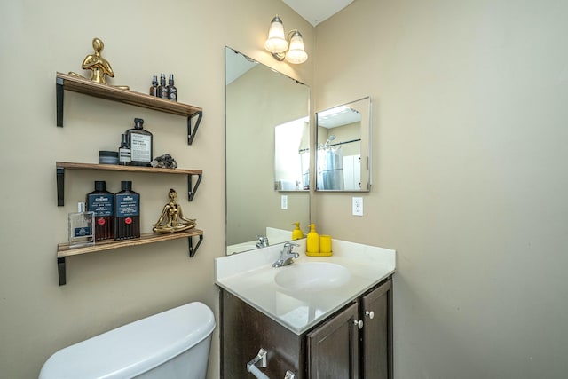 bathroom with toilet and vanity