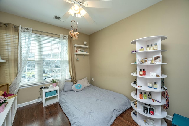 bedroom with visible vents, ceiling fan, baseboards, and wood finished floors