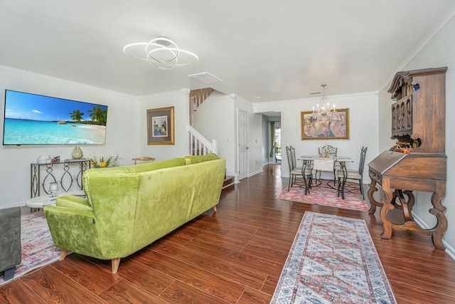 living room featuring ornamental molding, stairs, an inviting chandelier, and wood finished floors