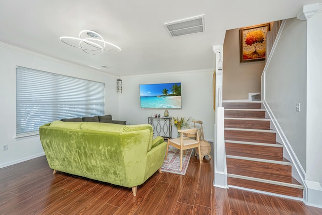 living room featuring dark wood-type flooring, stairway, and visible vents