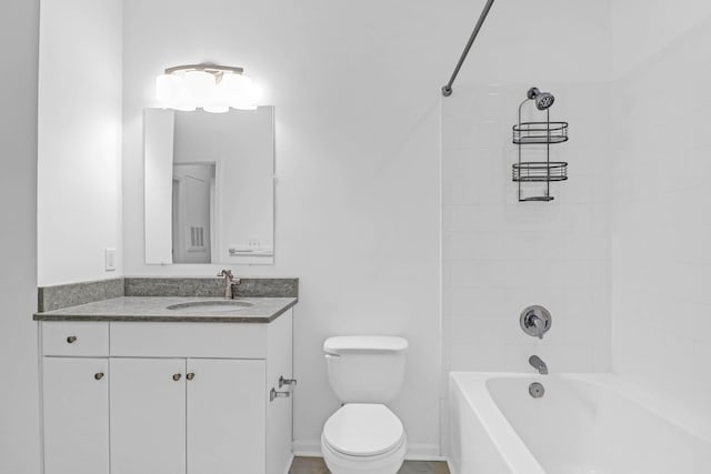 full bathroom with tiled shower / bath, vanity, and toilet