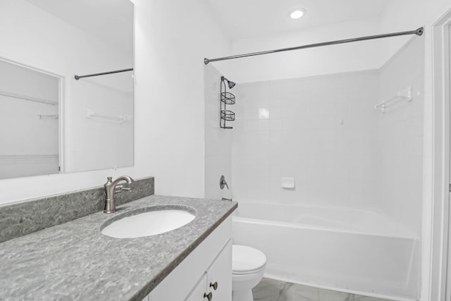 full bathroom with vanity, tiled shower / bath combo, and toilet