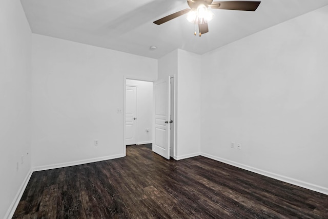 spare room with dark hardwood / wood-style flooring and ceiling fan