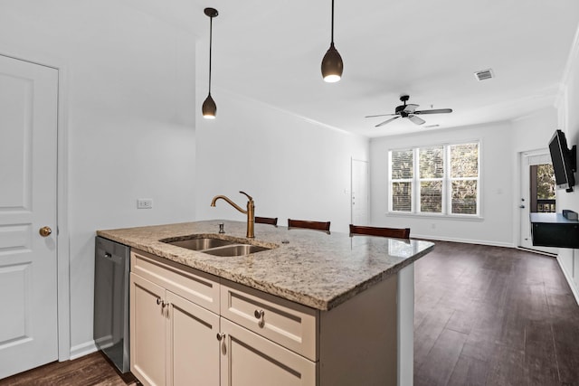 kitchen featuring sink, light stone counters, dark hardwood / wood-style flooring, dishwasher, and pendant lighting