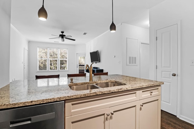 kitchen with sink, dishwasher, hanging light fixtures, light stone countertops, and dark hardwood / wood-style flooring