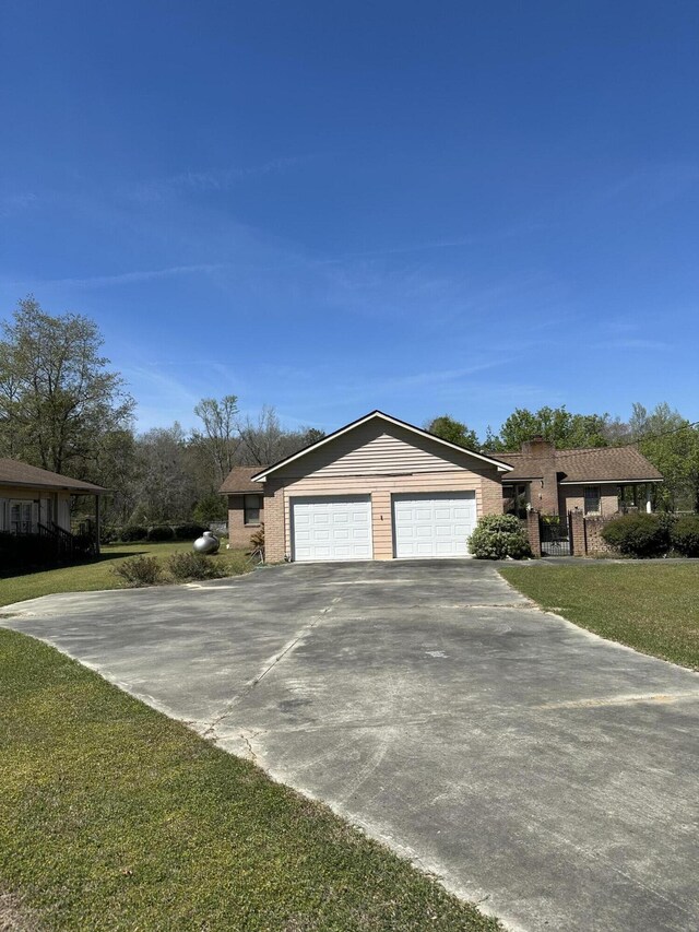 7819 Bells Hwy, Ruffin, SC 29475 - view of front of home with a front yard, an attached garage, brick siding, and concrete driveway