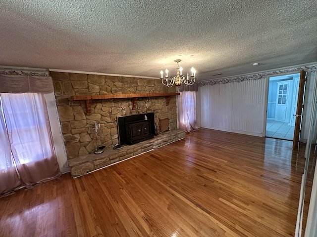 7819 Bells Hwy, Ruffin, SC 29475 - unfurnished living room featuring a textured ceiling, ornamental molding, wood finished floors, and a notable chandelier