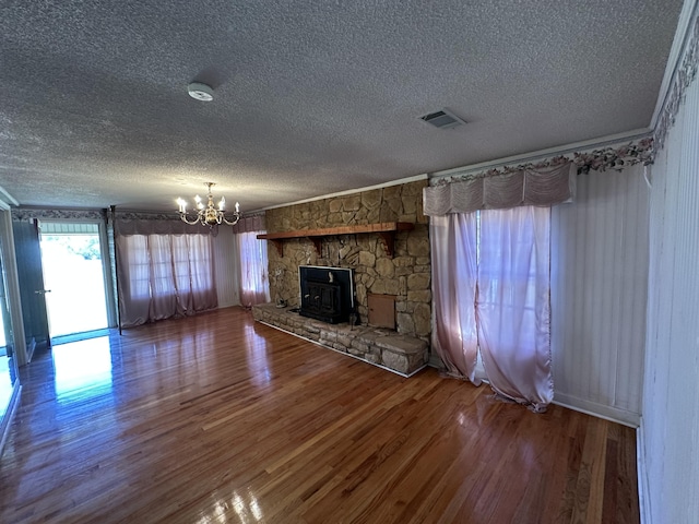 7819 Bells Hwy, Ruffin, SC 29475 - unfurnished living room featuring crown molding, a fireplace, wood finished floors, visible vents, and an inviting chandelier