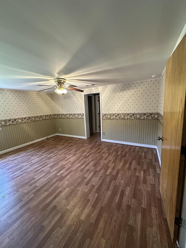 7819 Bells Hwy, Ruffin, SC 29475 - empty room with dark wood-type flooring, baseboards, wallpapered walls, and a ceiling fan