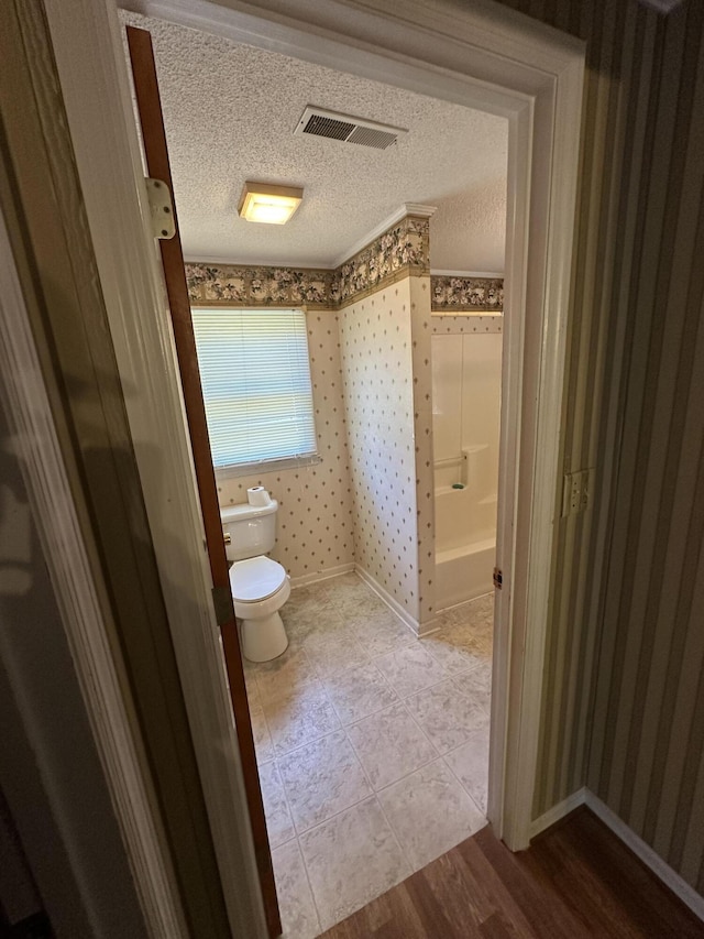 7819 Bells Hwy, Ruffin, SC 29475 - bathroom featuring toilet, baseboards, a textured ceiling, wallpapered walls, and visible vents