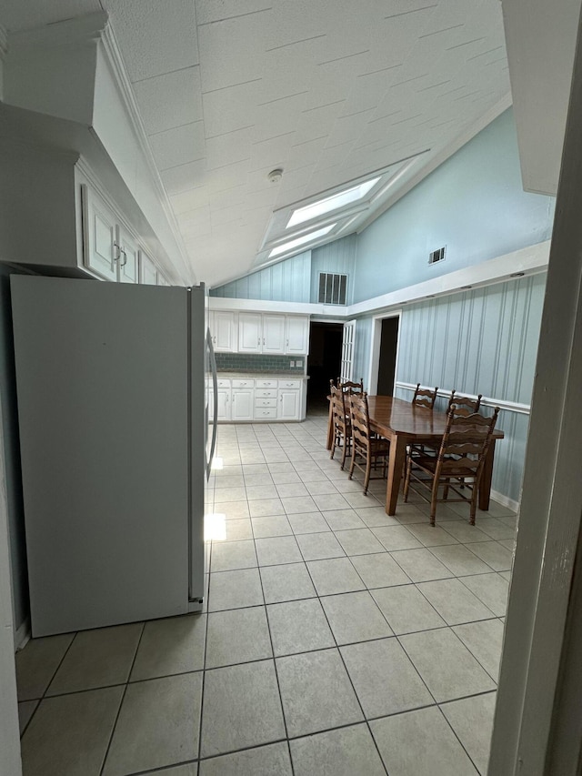 7819 Bells Hwy, Ruffin, SC 29475 - dining room featuring visible vents, lofted ceiling with skylight, and light tile patterned floors