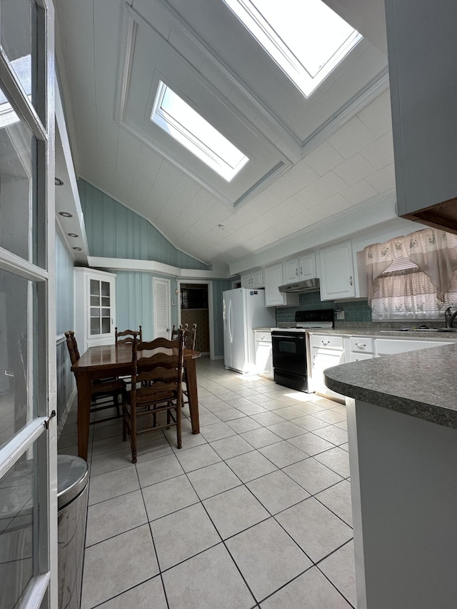 7819 Bells Hwy, Ruffin, SC 29475 - kitchen with light tile patterned flooring, vaulted ceiling with skylight, white cabinetry, white fridge with ice dispenser, and range with electric stovetop