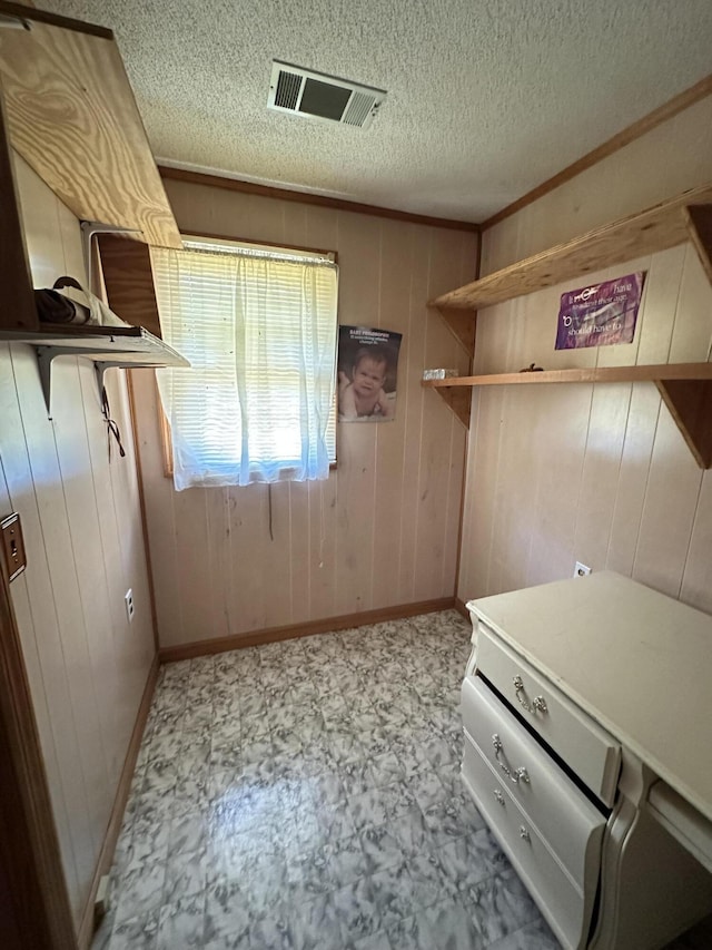 7819 Bells Hwy, Ruffin, SC 29475 - interior space with a textured ceiling, visible vents, wooden walls, baseboards, and tile patterned floors