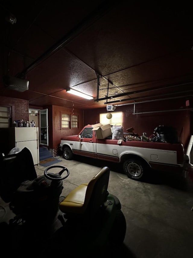 7819 Bells Hwy, Ruffin, SC 29475 - garage with a garage door opener and freestanding refrigerator