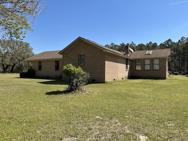 7819 Bells Hwy, Ruffin, SC 29475 - view of property exterior featuring a chimney, brick siding, crawl space, and a lawn