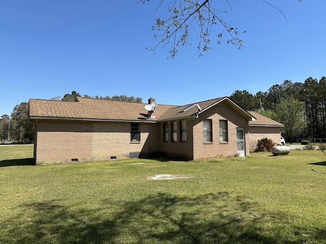 7819 Bells Hwy, Ruffin, SC 29475 - back of property featuring a chimney, brick siding, and a lawn