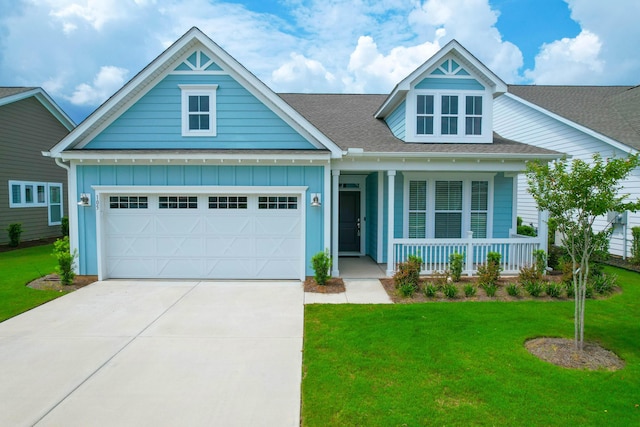 craftsman inspired home with a garage, a front lawn, and covered porch